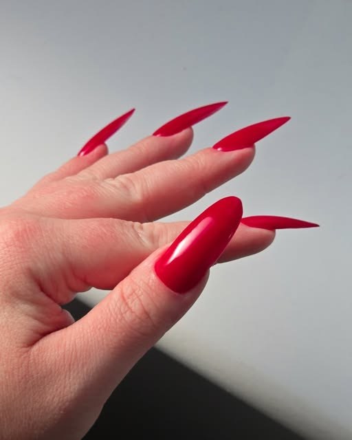 Long stiletto nails in glossy cherry red